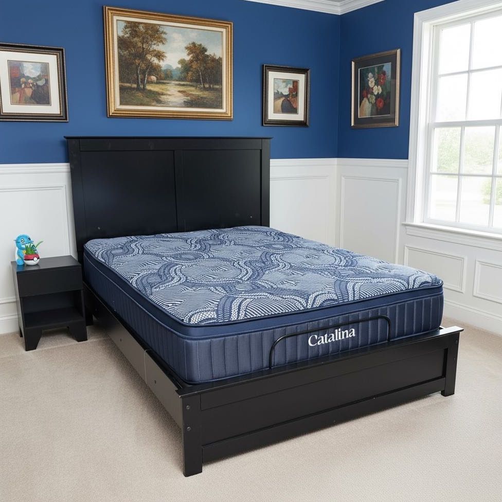 Catalina mattress with a blue patterned top and navy sides on a black wood bed